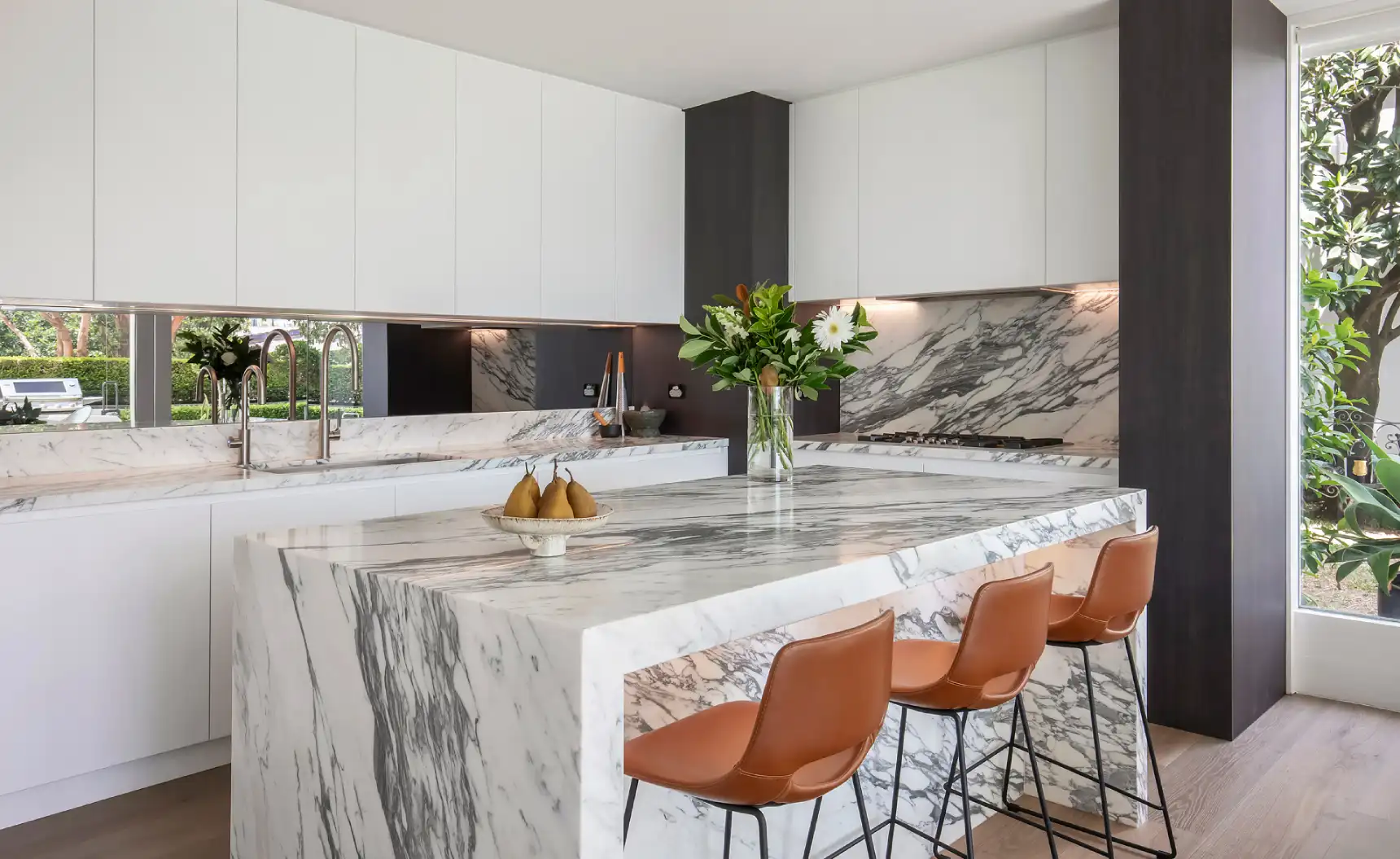 Modern kitchen with floral decoration and a marbled island